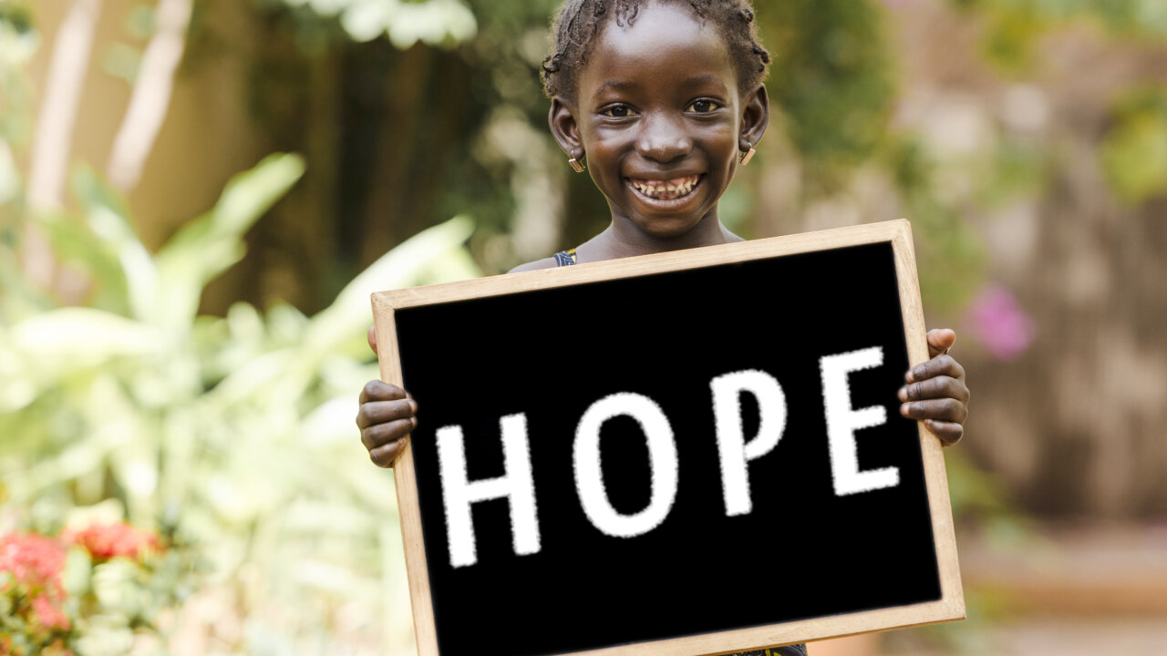 Image of Young African Girl holding signing titled hope